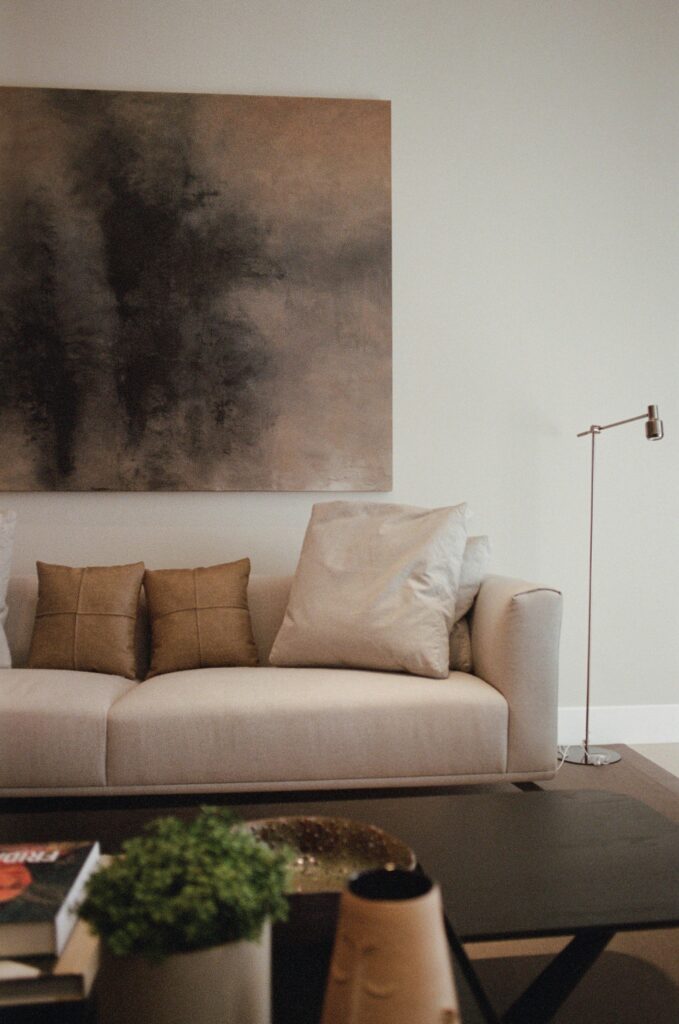 Neutral Living Room Ideas: 15 Warm and Layered Spaces neutral living room with oversized abstract wall art and soft layered seating