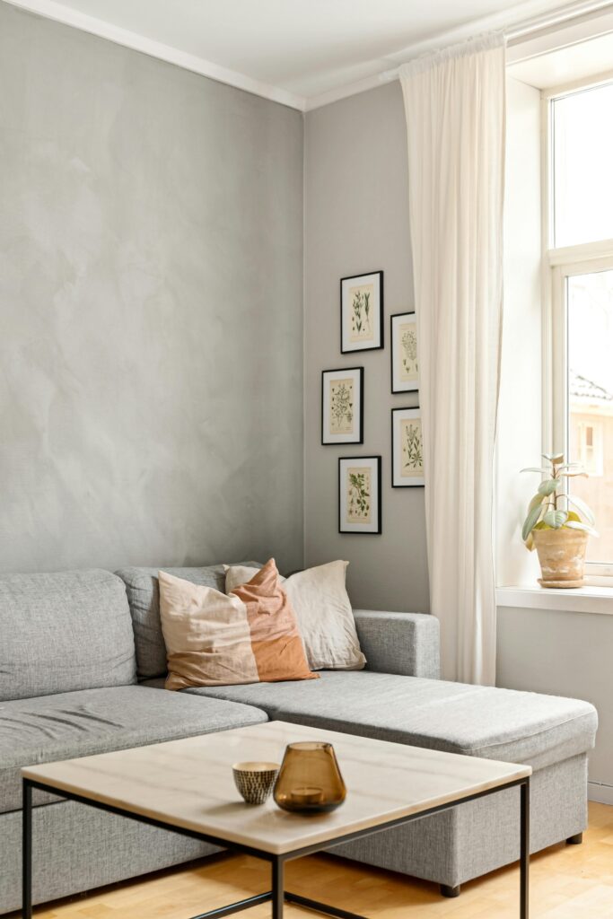 Neutral Living Room Ideas: 15 Warm and Layered Spaces neutral living room with sectional sofa and balanced gallery wall