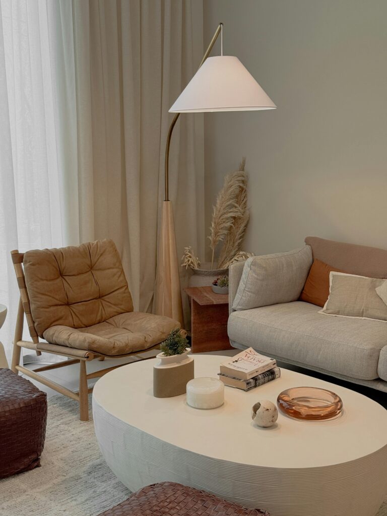 Neutral Living Room Ideas: 15 Warm and Layered Spaces layered neutral living room with round wood coffee table and soft beige textures