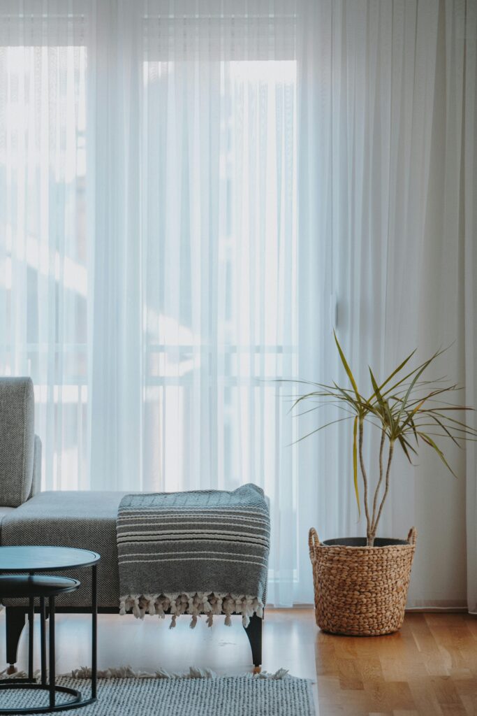 Neutral Living Room Ideas: 15 Warm and Layered Spaces neutral living room with sheer curtains and layered neutral textures