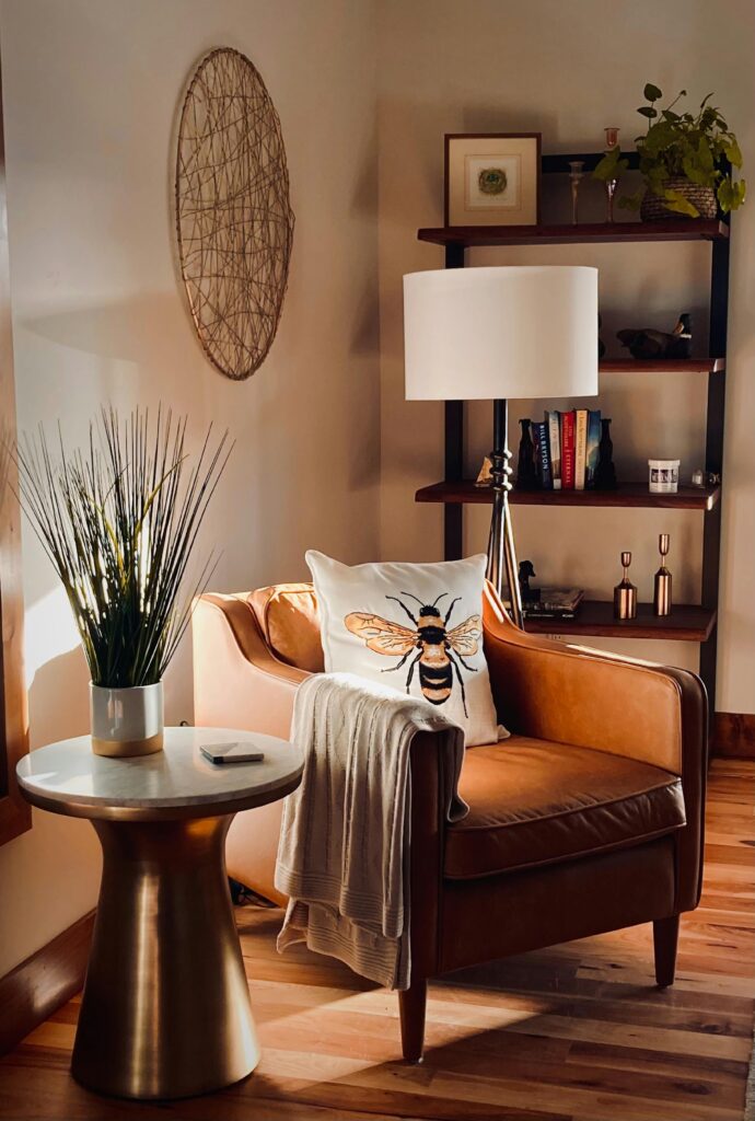 Neutral Living Room Ideas: 15 Warm and Layered Spaces warm neutral living room corner with chair, side table, and layered ambient lighting