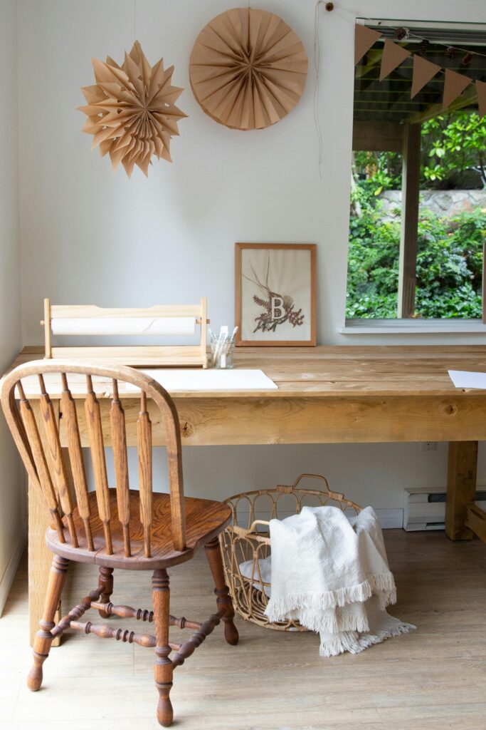 15 Neutral Office Decor Ideas That Feel Calm, Curated, and Intentional neutral office featuring natural wood desk, wooden chair, and soft beige wall decor