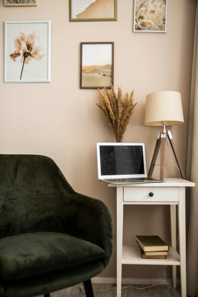 15 Neutral Office Decor Ideas That Feel Calm, Curated, and Intentional compact neutral office nook with deep olive accent chair, small desk, soft neutral wall art, and warm layered styling