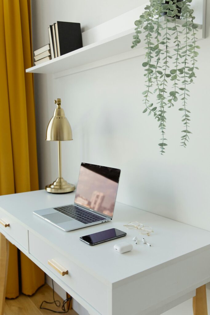15 Neutral Office Decor Ideas That Feel Calm, Curated, and Intentional small neutral office with floating wall shelf, brass desk lamp, and trailing greenery